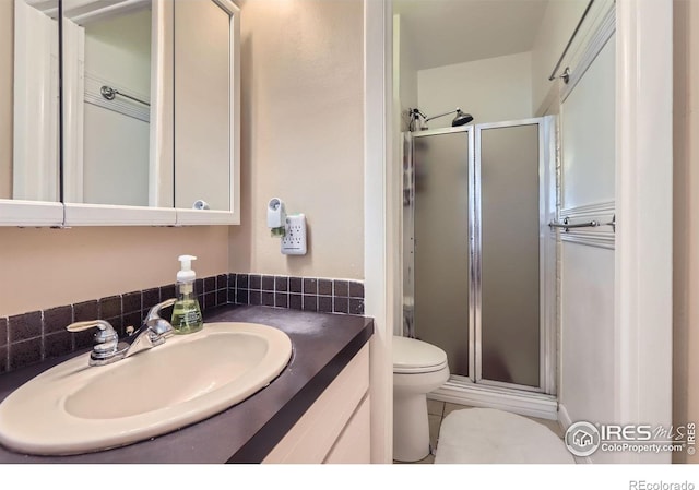 full bathroom with toilet, a shower stall, vanity, and tile patterned floors