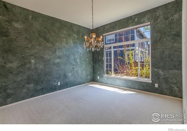 2409 Rock Creek Dr, Fort Collins, CO 80528 - carpeted spare room featuring a chandelier and baseboards