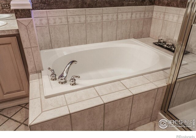 2409 Rock Creek Dr, Fort Collins, CO 80528 - full bath featuring a bath, tile patterned flooring, vanity, and a shower with shower door