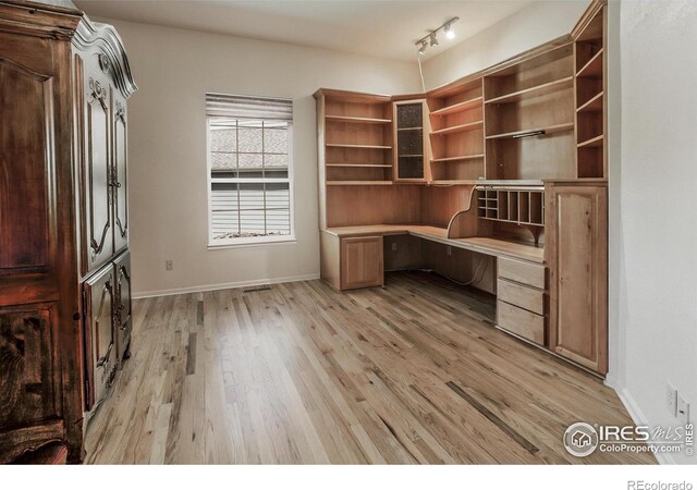 2409 Rock Creek Dr, Fort Collins, CO 80528 - unfurnished office with built in study area, light wood finished floors, and baseboards