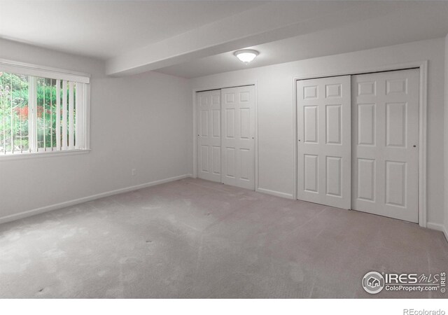 2409 Rock Creek Dr, Fort Collins, CO 80528 - unfurnished bedroom with two closets, carpet, and baseboards