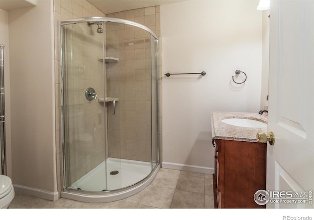 2409 Rock Creek Dr, Fort Collins, CO 80528 - bathroom featuring a shower stall, baseboards, vanity, and tile patterned floors
