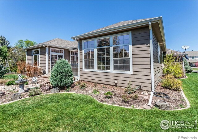 2409 Rock Creek Dr, Fort Collins, CO 80528 - view of front of house featuring a front lawn