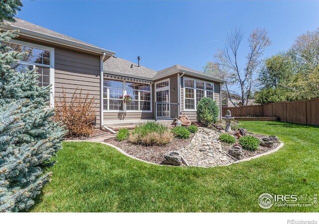 2409 Rock Creek Dr, Fort Collins, CO 80528 - back of house with a shingled roof and a sunroom