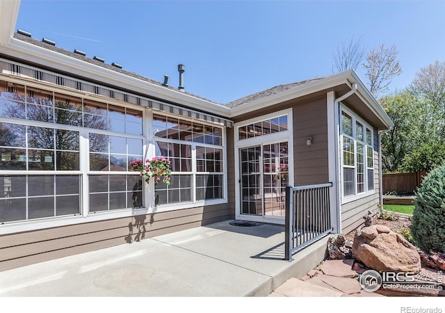 2409 Rock Creek Dr, Fort Collins, CO 80528 - doorway to property featuring fence and a patio area