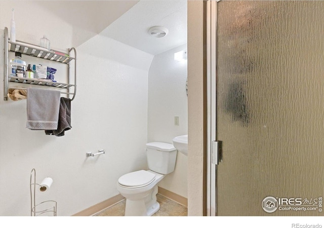 2315 Spruce St, Boulder, CO 80302 - bathroom featuring toilet, tile patterned flooring, a stall shower, and baseboards