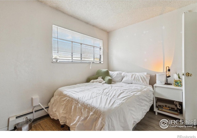 2315 Spruce St, Boulder, CO 80302 - bedroom with a baseboard radiator, a textured ceiling, and wood finished floors