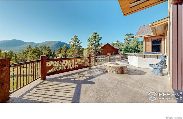1049 Pine Knoll Dr, Estes Park, CO 80517 - view of patio featuring a fire pit and a mountain view