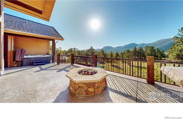 1049 Pine Knoll Dr, Estes Park, CO 80517 - view of patio / terrace featuring a hot tub, a mountain view, and an outdoor fire pit