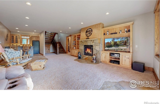 1049 Pine Knoll Dr, Estes Park, CO 80517 - carpeted living room featuring a stone fireplace, stairs, recessed lighting, and baseboards