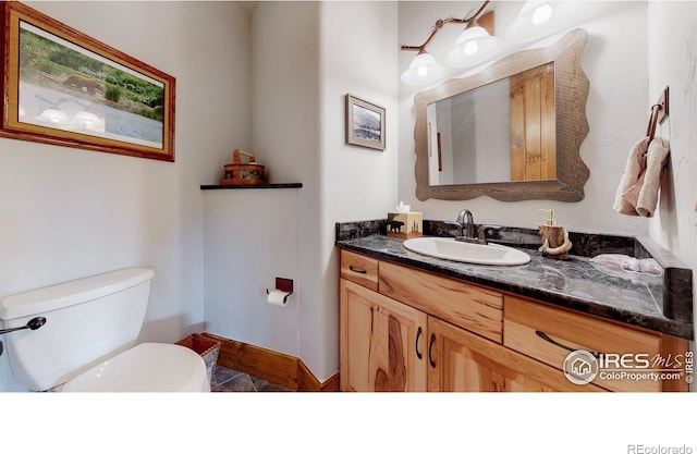 1049 Pine Knoll Dr, Estes Park, CO 80517 - half bath featuring vanity, toilet, and baseboards