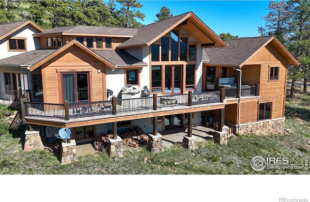 1049 Pine Knoll Dr, Estes Park, CO 80517 - rear view of house with roof with shingles, a wooden deck, and a patio