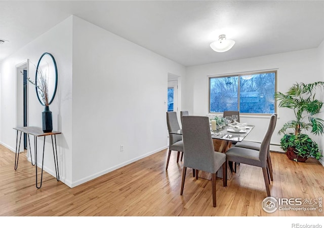 dining room with light wood-style floors and baseboards
