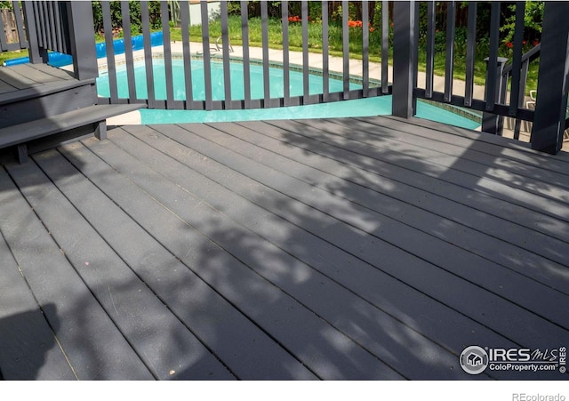 wooden terrace with an outdoor pool