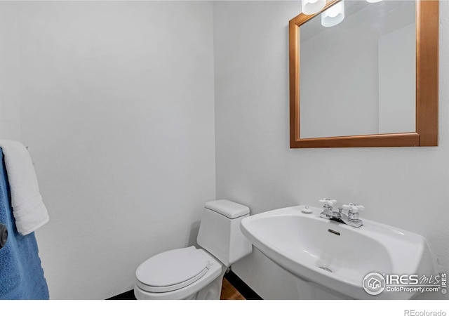 half bathroom with a sink and toilet