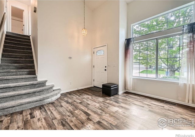 1842 Reliance Cir, Superior, CO 80027 - entryway with stairway, baseboards, wood finished floors, a chandelier, and a towering ceiling