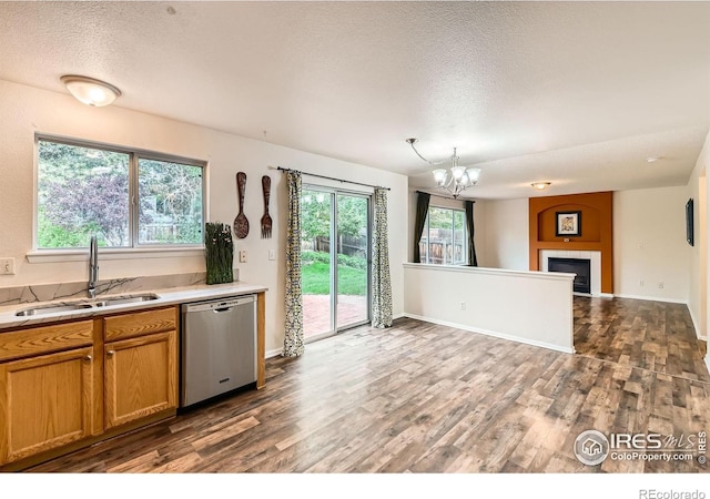 1842 Reliance Cir, Superior, CO 80027 - kitchen with dishwasher, a sink, a textured ceiling, dark wood-type flooring, and a chandelier