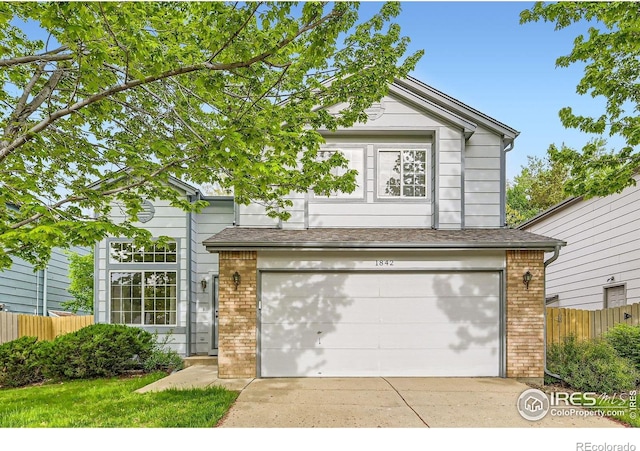 1842 Reliance Cir, Superior, CO 80027 - traditional-style house with brick siding, fence, a garage, and driveway