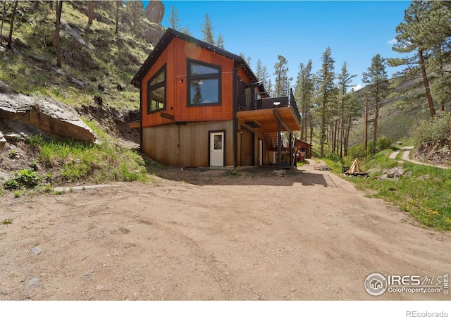 200 Falls Creek Dr, Bellvue, CO 80512 - view of home's exterior featuring a deck, stairway, and driveway