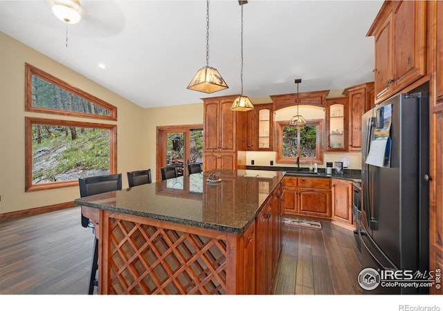 200 Falls Creek Dr, Bellvue, CO 80512 - kitchen with freestanding refrigerator, dark wood-style flooring, a center island, brown cabinets, and recessed lighting