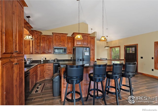 200 Falls Creek Dr, Bellvue, CO 80512 - kitchen featuring black fridge with ice dispenser, stainless steel microwave, wood finish floors, dark countertops, and high vaulted ceiling