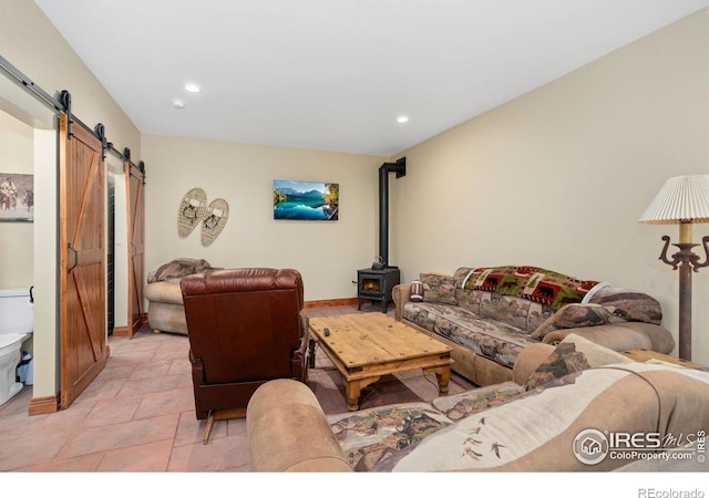 200 Falls Creek Dr, Bellvue, CO 80512 - living area with a barn door, recessed lighting, a wood stove, and baseboards