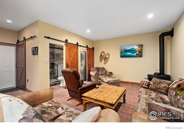 200 Falls Creek Dr, Bellvue, CO 80512 - living room with stacked washer / dryer, a barn door, recessed lighting, and baseboards