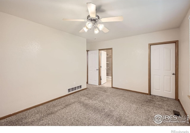 unfurnished bedroom featuring carpet floors, baseboards, ensuite bathroom, and a ceiling fan