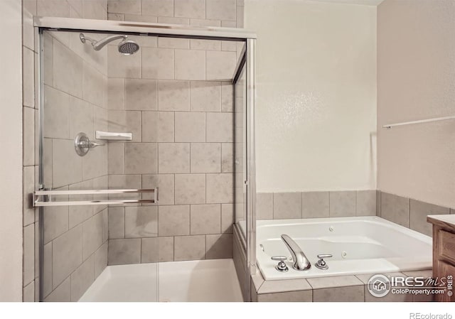 bathroom with a stall shower and a tub with jets