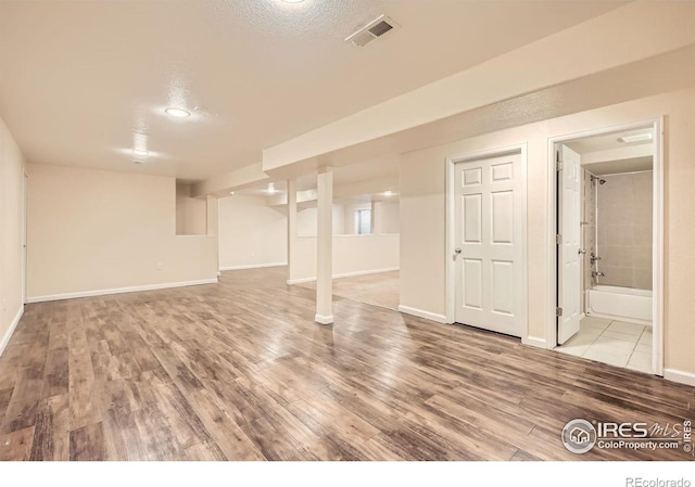 finished below grade area with wood finished floors and baseboards
