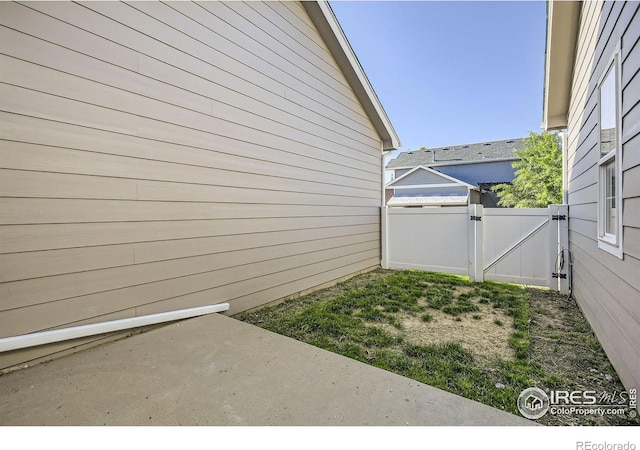 view of yard featuring a gate, a patio area, and fence