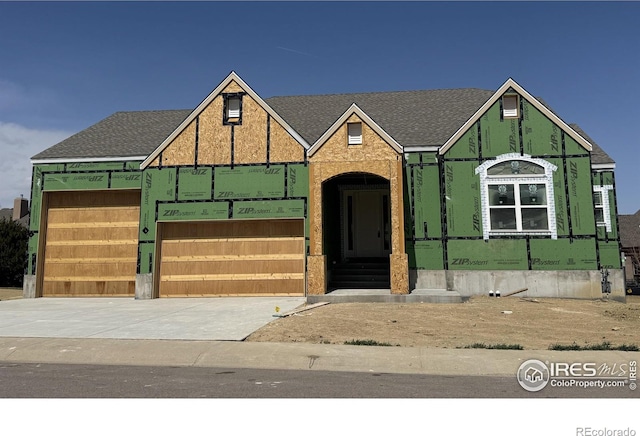 1156 Bordeaux Dr, Fort Collins, CO 80526 - view of front facade with driveway, a garage, and a shingled roof