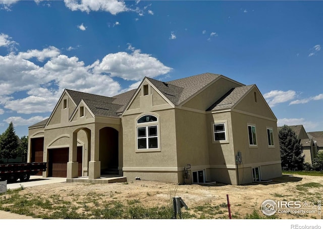 1156 Bordeaux Dr, Fort Collins, CO 80526 - view of front of property with a garage, stucco siding, and roof with shingles