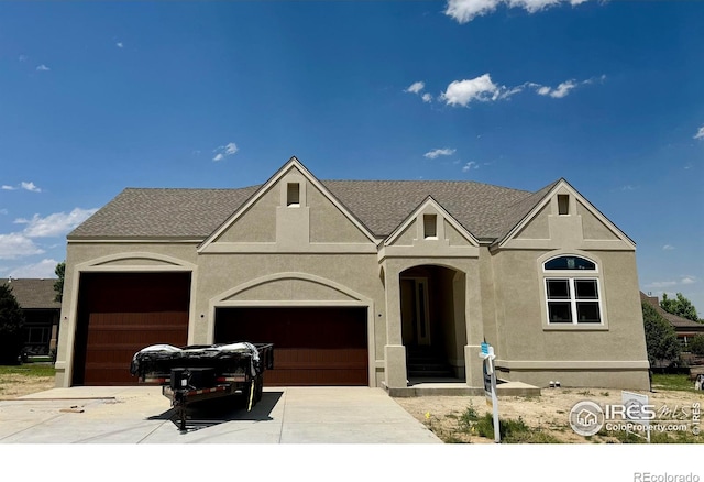 1156 Bordeaux Dr, Fort Collins, CO 80526 - view of front facade with a garage, driveway, and stucco siding