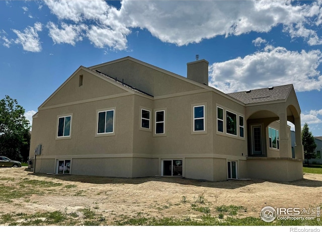 1156 Bordeaux Dr, Fort Collins, CO 80526 - view of home's exterior featuring a chimney and stucco siding