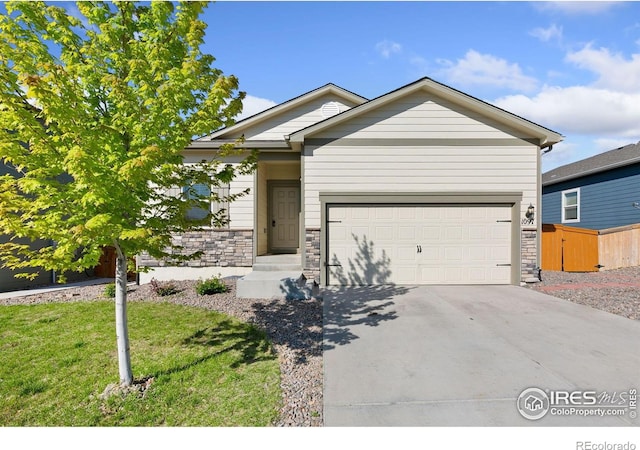 single story home featuring concrete driveway, an attached garage, and stone siding