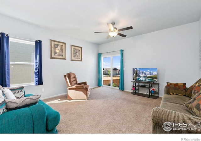 living room with ceiling fan, carpet, and baseboards