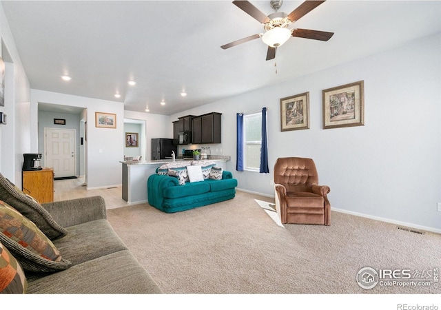 living room with a ceiling fan, light carpet, baseboards, and recessed lighting
