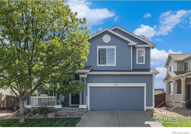view of front of home with driveway, a garage, fence, and a porch