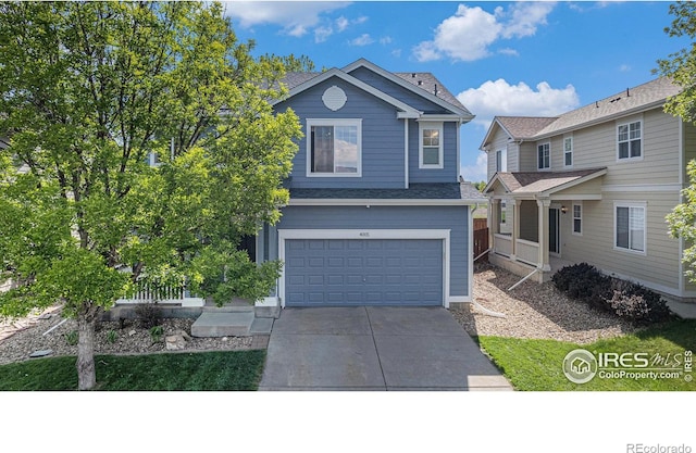 view of front of property with a garage, concrete driveway, and roof with shingles