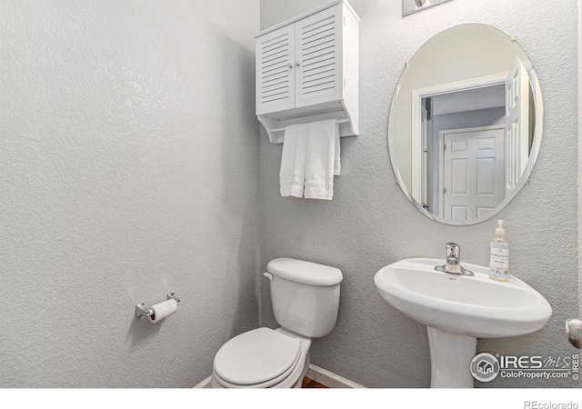 bathroom with toilet and a sink