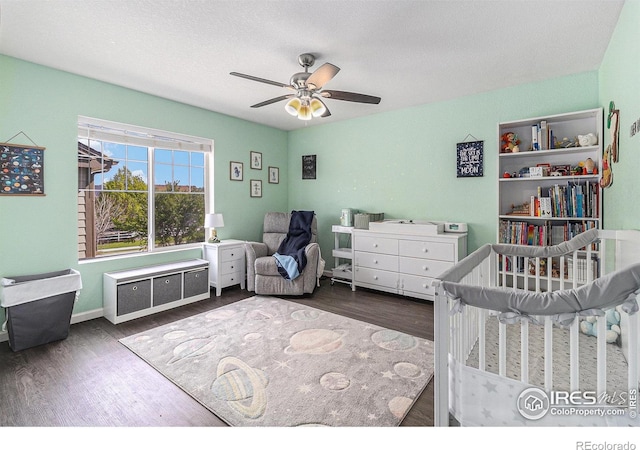 bedroom with wood finished floors, ceiling fan, and a textured ceiling