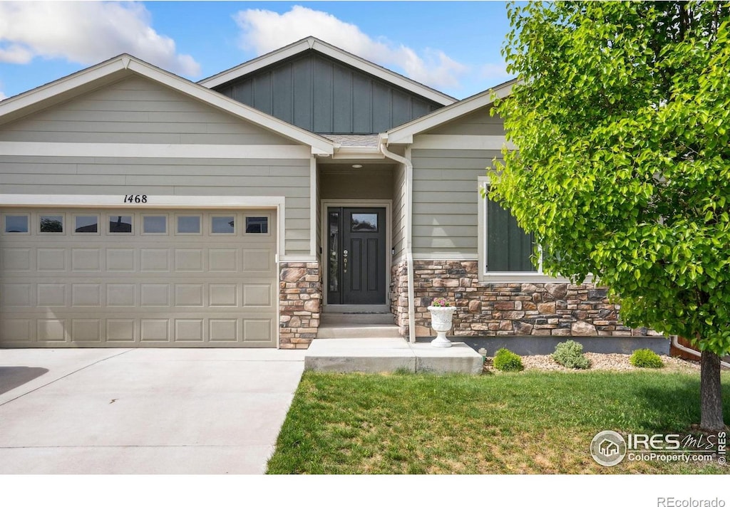 1468 Moraine Valley Dr, Severance, CO 80550 - craftsman house featuring an attached garage, board and batten siding, driveway, stone siding, and a front yard