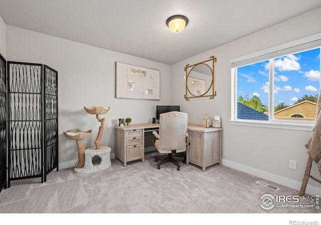 office with light carpet and baseboards