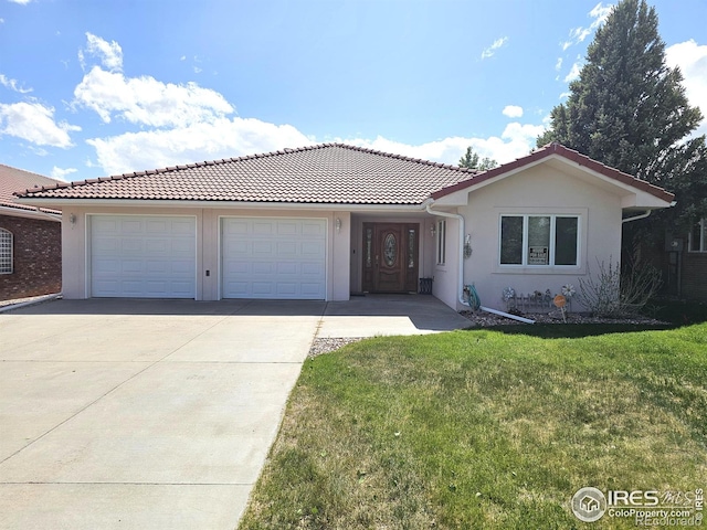 107 Fairway Ln, Fort Morgan, CO 80701 - ranch-style house with concrete driveway, a garage, a front yard, stucco siding, and a tile roof