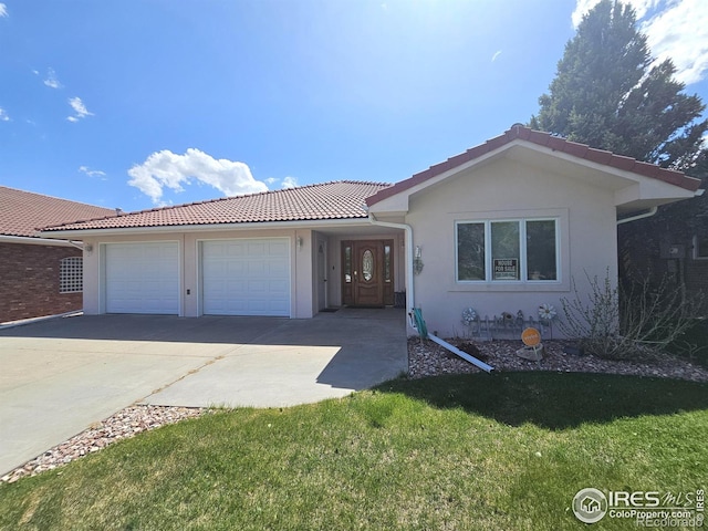 107 Fairway Ln, Fort Morgan, CO 80701 - ranch-style house with driveway, a garage, a tile roof, stucco siding, and a front yard