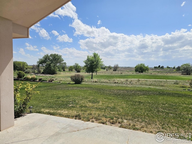 107 Fairway Ln, Fort Morgan, CO 80701 - view of green lawn featuring a patio and a view of rural / pastoral area
