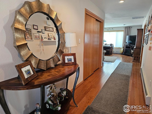 107 Fairway Ln, Fort Morgan, CO 80701 - hall featuring a baseboard heating unit, wood finished floors, baseboard heating, a desk, and recessed lighting
