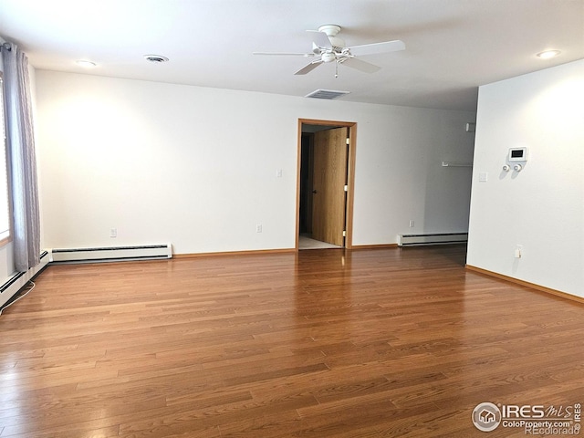 107 Fairway Ln, Fort Morgan, CO 80701 - spare room with a baseboard heating unit, a ceiling fan, wood finished floors, and baseboards