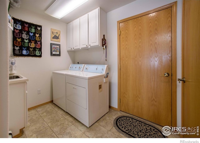 107 Fairway Ln, Fort Morgan, CO 80701 - laundry area with washer and clothes dryer, cabinet space, baseboards, and light tile patterned floors